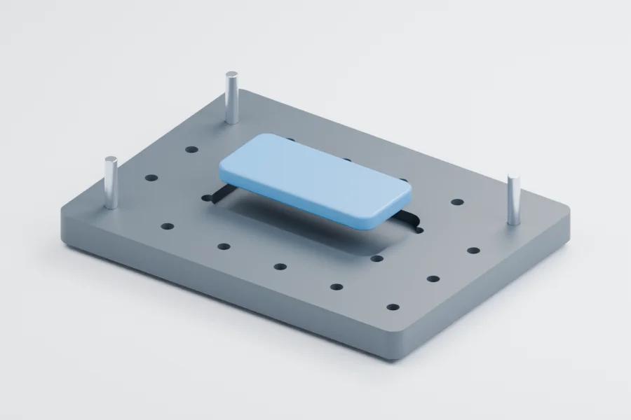 Illustrative fixture plate with round holes, a pocket, locating pins and a sample workpiece